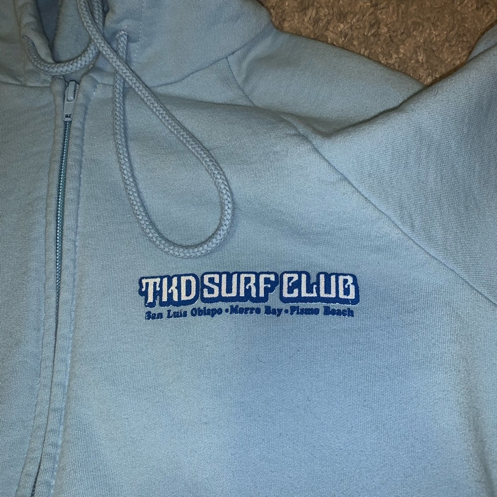a light blue zip up jacket